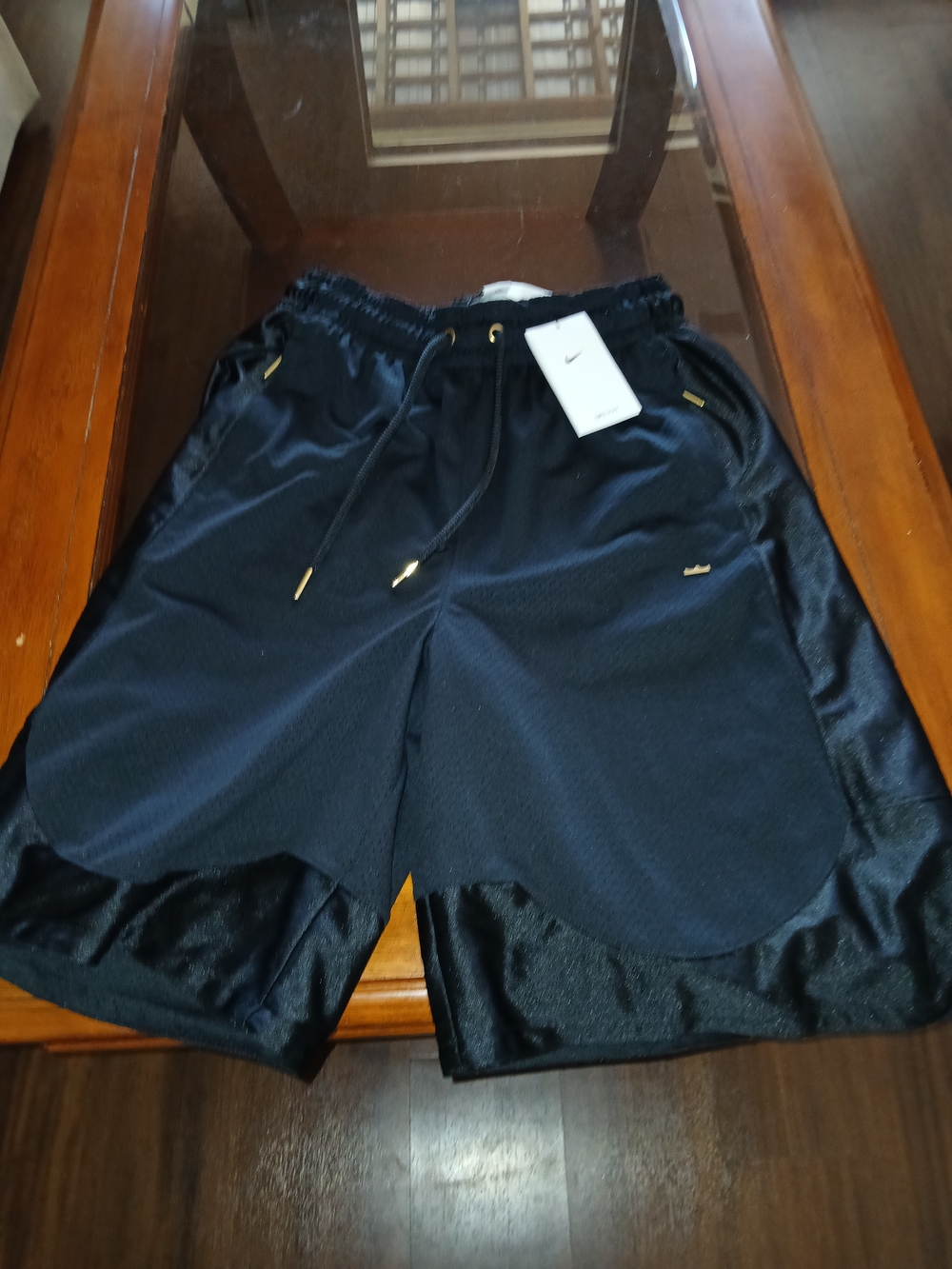 Nike Black Athletic Shorts with Gold Accents